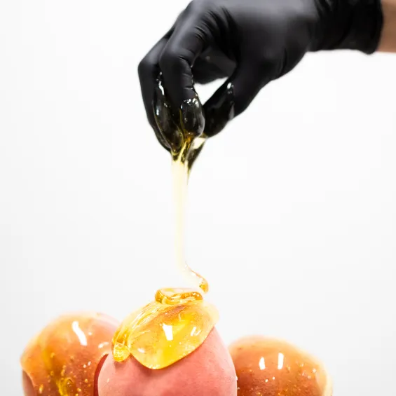 Sugaring paste gloved hand over peaches!